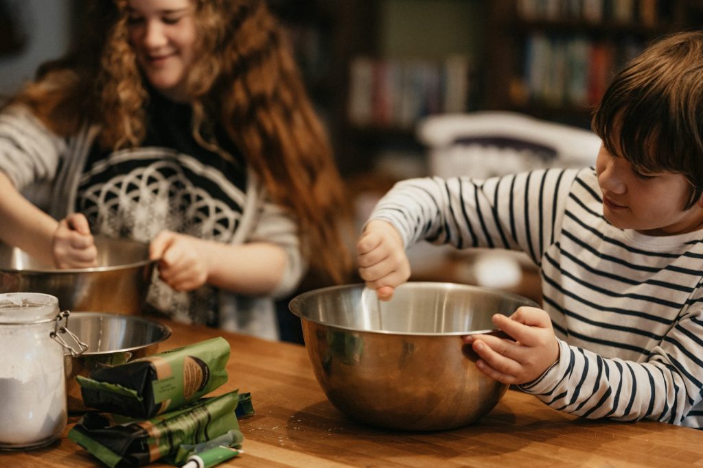 Children mixing ingredients in bowls during a fun baking activity in the kitchen