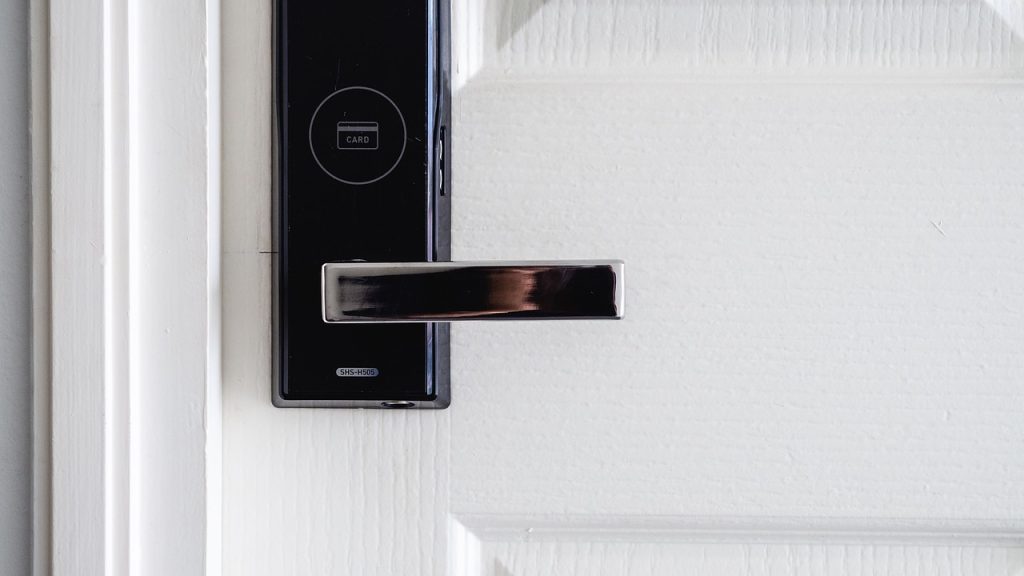 Modern digital door lock with card access on white door handle